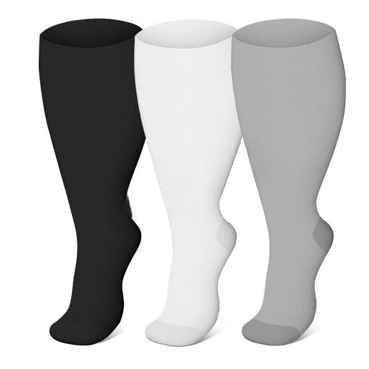 Three pairs of knee-high socks in black, white, and gray on a white background