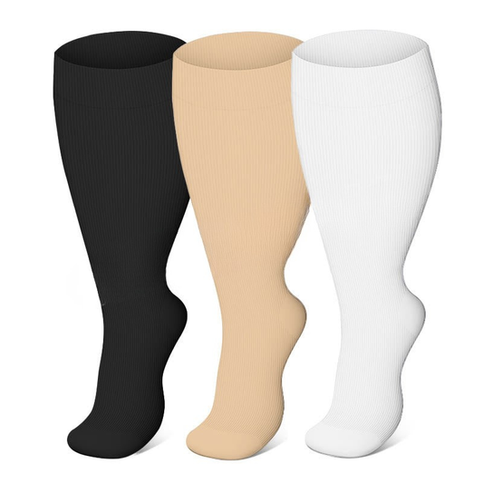 Three pairs of compression socks in black, beige, and white on a white background.
