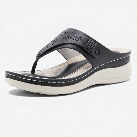 Black sandal with white sole on a light gray background